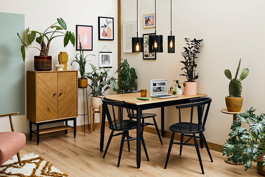 A living space containing a Monza small dining table, Heritage chairs and Monza universal cabinet