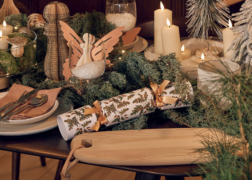 A close up of a Christmas cracker on an ercol dining table