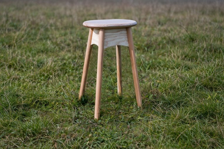 An ercol x Sylva Foundation side table, sat on grass