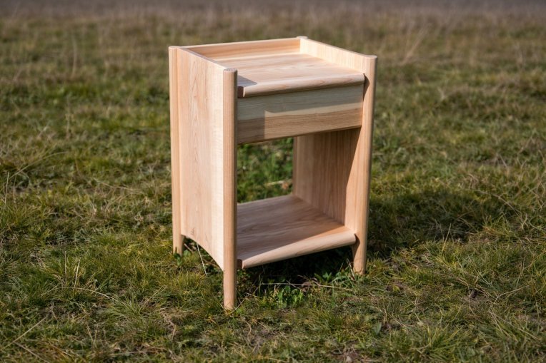 An ercol x Sylva Foundation bedside cabinet, sat on grass