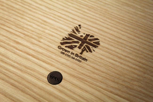 A close up of some timber showing the clear grain pattern, and stamped with a Grown in Britain certification mark.
