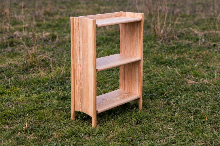 An ercol x Sylva Foundation bookcase, sat on grass