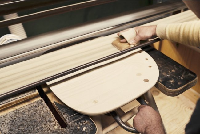 The Windsor Seat being sanded by hand on the pad-sander