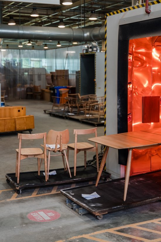 The Lara Chair, Butterfly Chair and Fairmile table being wheeled through the drying tunnel 